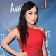 Ivory Aquino wears a one-shoulder red dress with sparkling waist detail on the red carpet.
